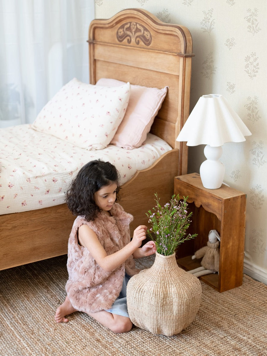 Beautiful wooden sleigh bed, vases and flowers all make this the perfect place to have Little Myrtle cotton bed sheets in the gorgeous wax flower print