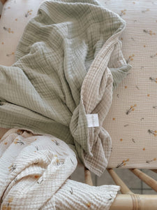 Softies come in 3 sizes - Little Softie, Medium Softie and our Big Softie. They are the most incredibly soft and luxurious throws and blankets. All made from 8 crinkly layers of GOTS organic cotton and work beautifully here with our Billy Button bed sheet and swaddle. Mix and match with these beautiful neutral designs all influenced by Australian flora.