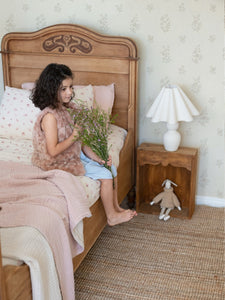 This sleigh bed brings out all the vintage feels with LIttle Myrtle pink clay softie on the wax flower bed sheets it works together beautifully. What a great space for a child to play and call their own.