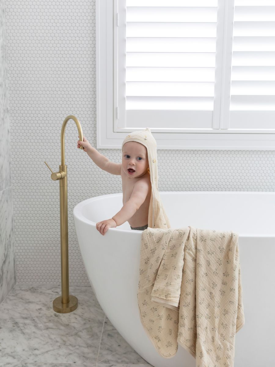 Baby wearing vintage scandi cotton hooded towel