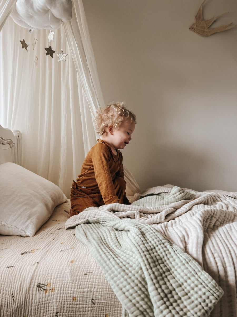 This child bedroom is neutral and soft and makes them so happy. If you feel the incredible quality of Little Myrtles bed sheets and Softies you would feel the same. Made from eight layers of crinkly soft gauze cotton it is soft and luxury all at the same time. Pictured here are the billy button bed sheets and our moss green and neutral softie.