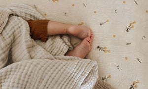 The most beautiful scandi vintage inspired cot sheets and single bedding with neutral colours and billy button flowers made from GOTS organic cotton.