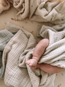 The Softest GOTS Organic certified baby bassinet sheets with a vintage scandi design and Asutralian yellow billy button flowers on a neutral background